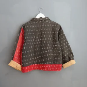 black kantha chore jacket hanging on a wall