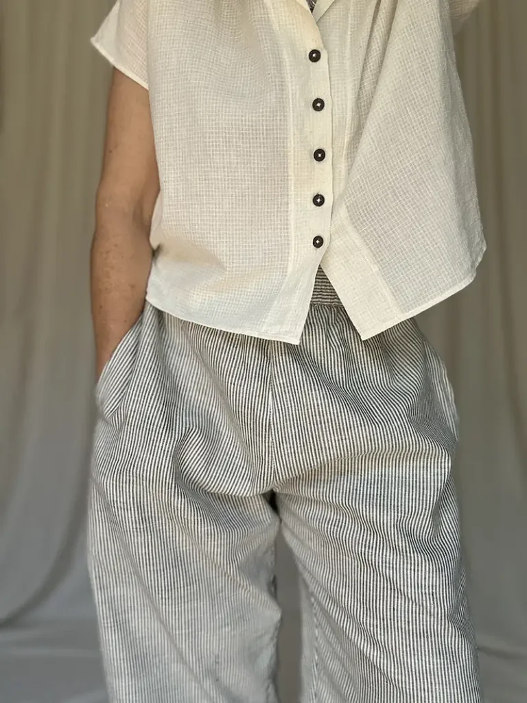 woman wearing pull on cotton trousers and white short shirt