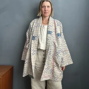 woman wearing long blue and white vintage kantha jacket