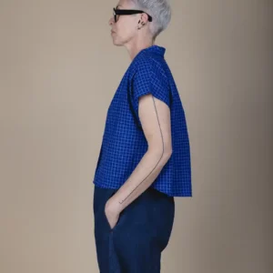 woman with grey hair wearing a short sleeve blue shirt