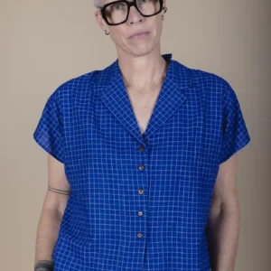 zoom in woman with grey hair wearing a short sleeve blue shirt