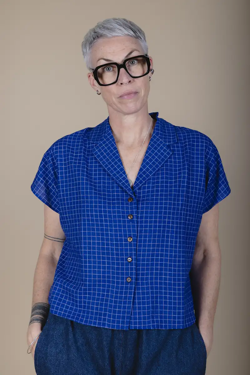 zoom in woman with grey hair wearing a short sleeve blue shirt