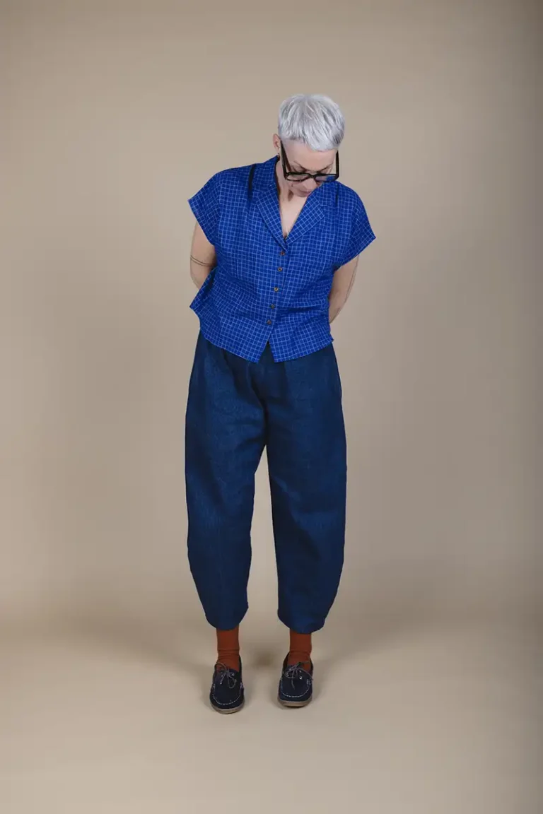 full length picture of woman wearing short shirt and barrel leg trousers