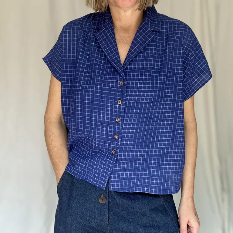 woman wearing blue check short sleeve shirt with jeans