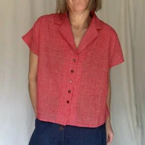 woman wearing a red check short sleeve shirt