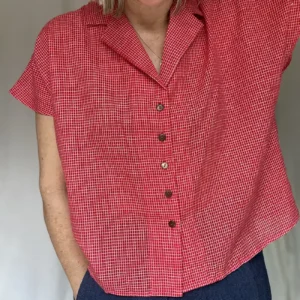 woman wearing a red check short sleeve shirt