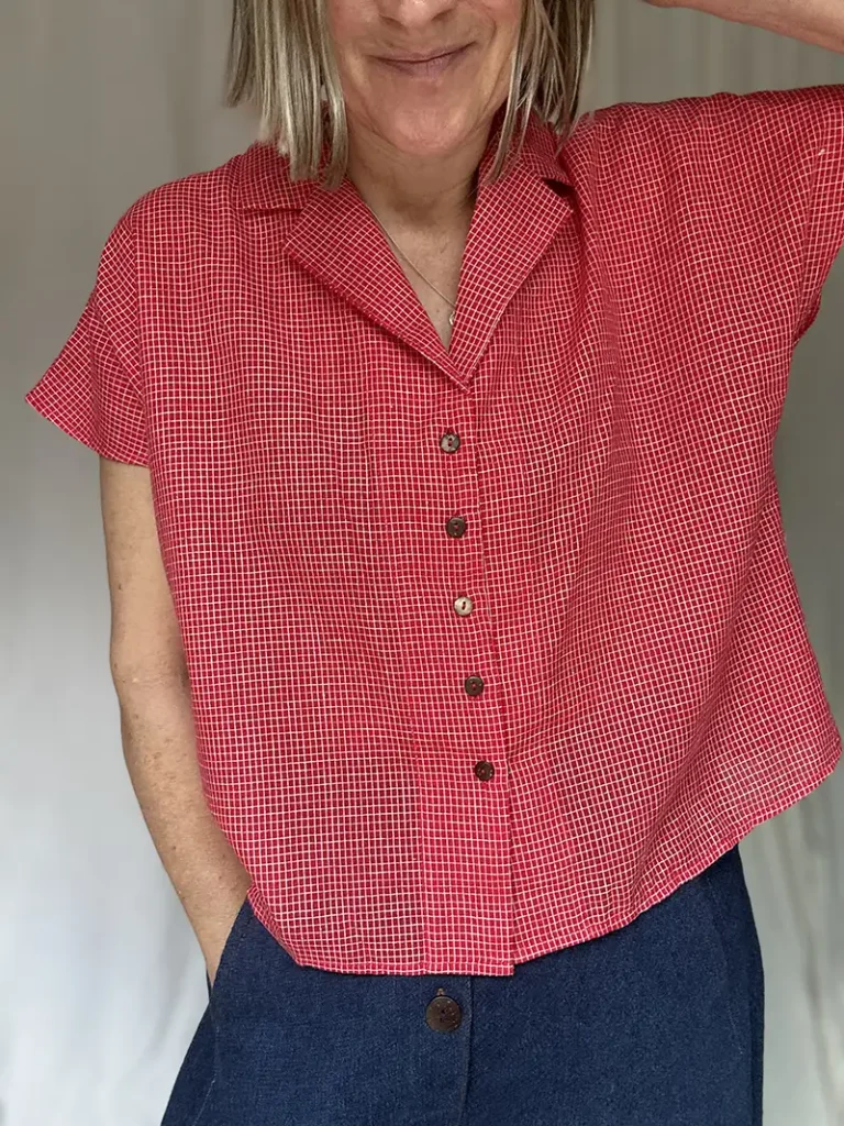 woman wearing a red check short sleeve shirt