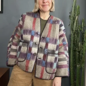 woman wearing camel and red check wool jacket