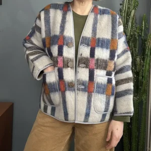 zoom in of woman wearing a blanket jacket