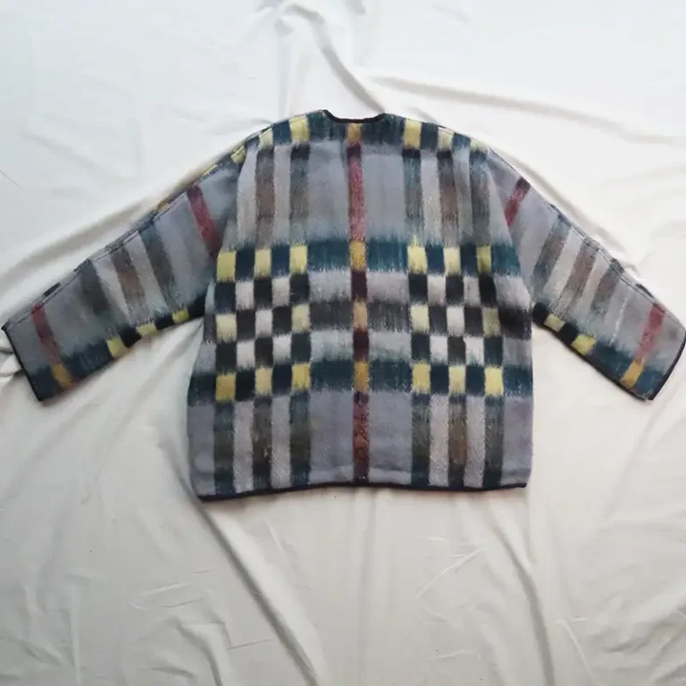 back view of a blanket jacket with handwoven check