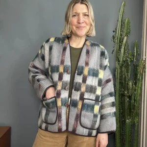 woman wearing neutral check blanket jacket