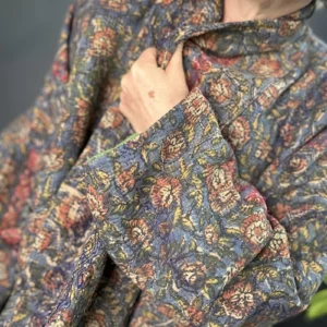 zoom in of woman wearing a dark floral kantha jacket
