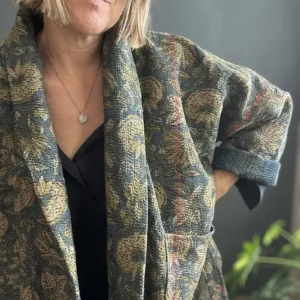woman wearing a dark floral kantha jacket