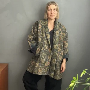 woman wearing a dark floral kantha jacket