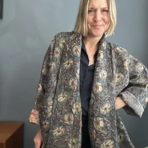 woman wearinga long dark kantha jacket