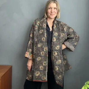 woman wearinga long dark kantha jacket