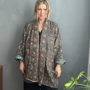 woman wearing a long vintage kantha jacket