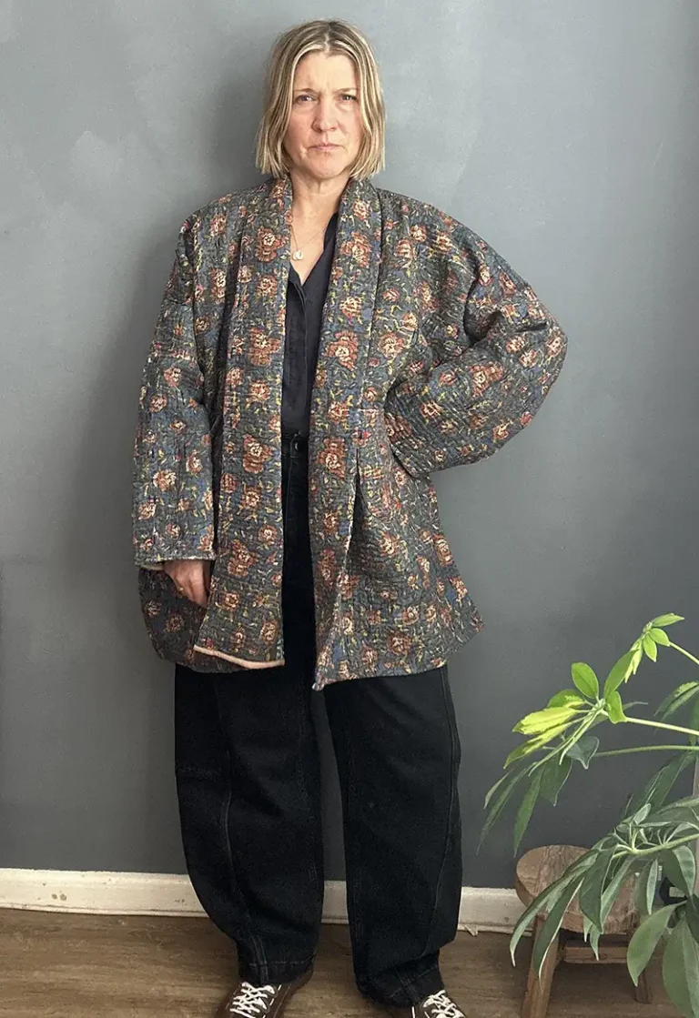woman wearing long kantha fabric jacket