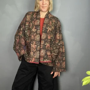 woman wering a dark floral indian kantha jacket