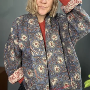 woman wearing a dark floral kantha stitched jacket