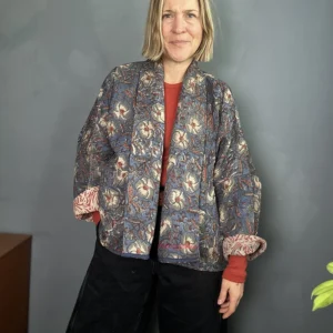 woman wearing a dark blue floral indian kantha jacket