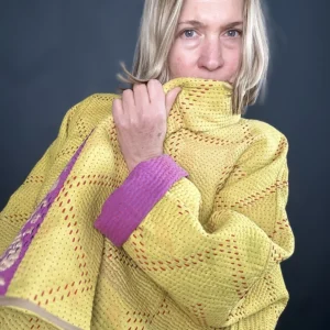 woman wearing a bright yellow kantha jacket