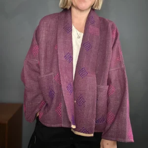 zoom in woman wearing deep wine coloured kantha quilted jacket