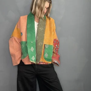 woman wearing a rainbow coloured kantha stitched jacket