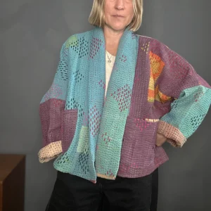 woman wearing a blue and purple kantha stitched jacket