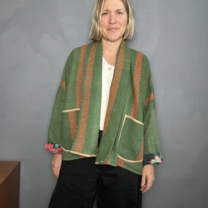 woman wearing a reversible green quilted kantha jacket
