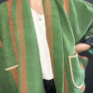 zoom in woman wearing a reversible green quilted kantha jacket