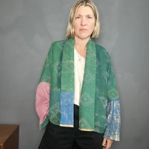 woman wearing a green, blue and pink kantha quilted jacket