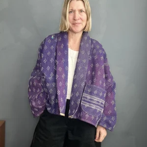 woman wearing a purple kantha jacket and black trousers