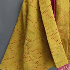 zoom in deatails of a yellow stitched kantha jacket