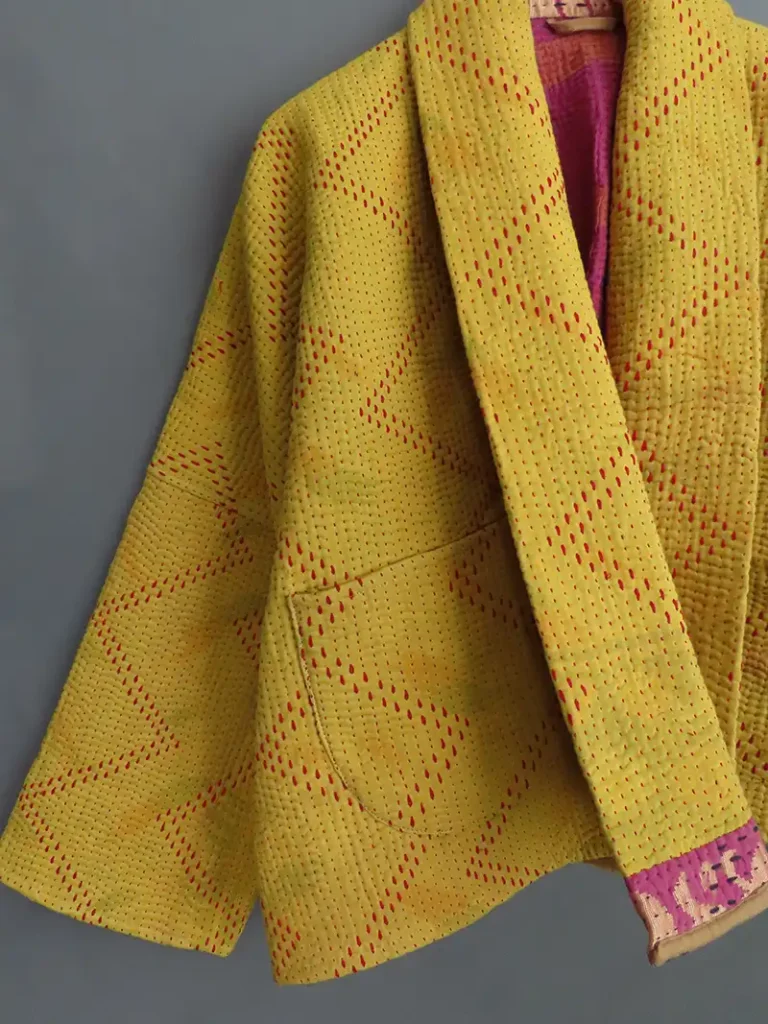 zoom in deatails of a yellow stitched kantha jacket