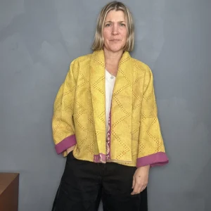 woman wearing a yellow and pink reversible kantha quilted jacket
