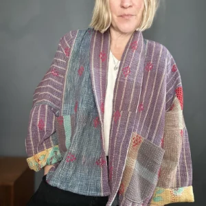 zoom in woman wearing muted purple short kantha jacket