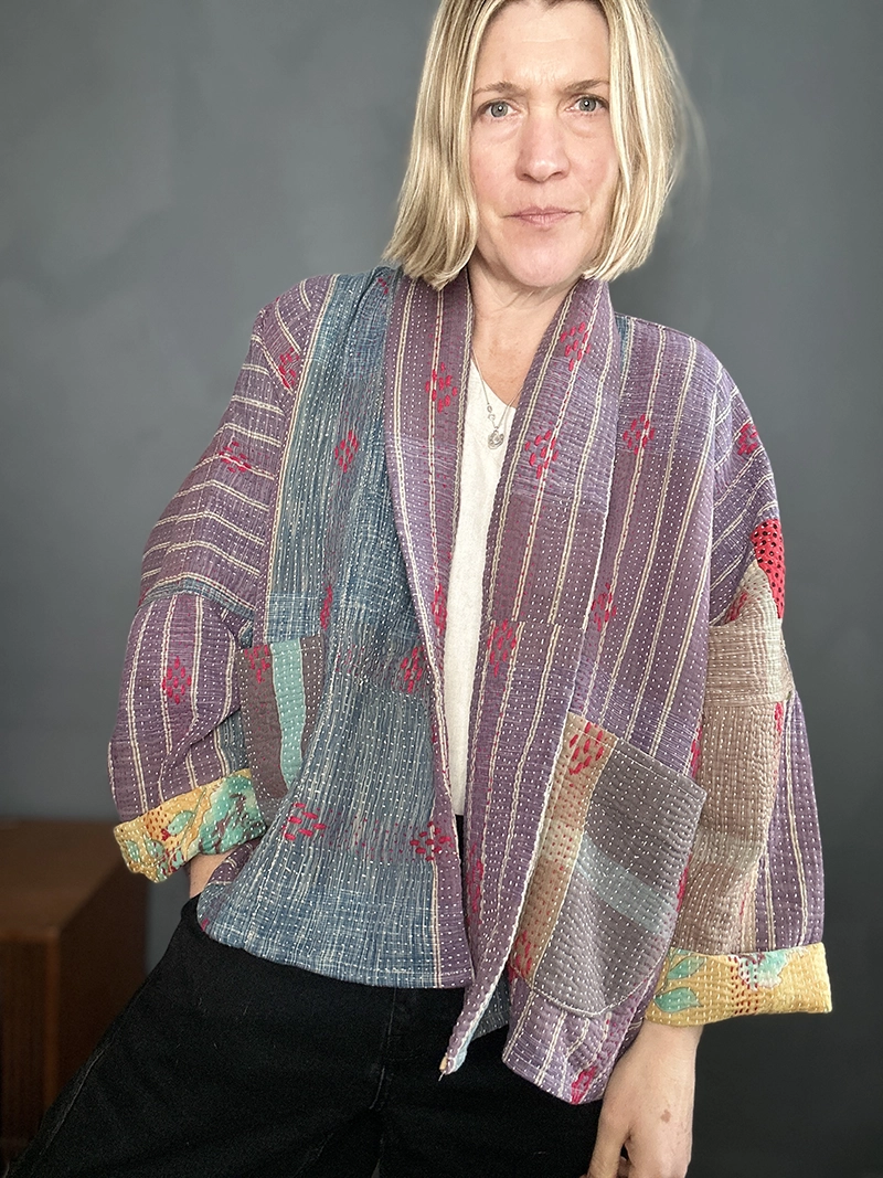 zoom in woman wearing muted purple short kantha jacket