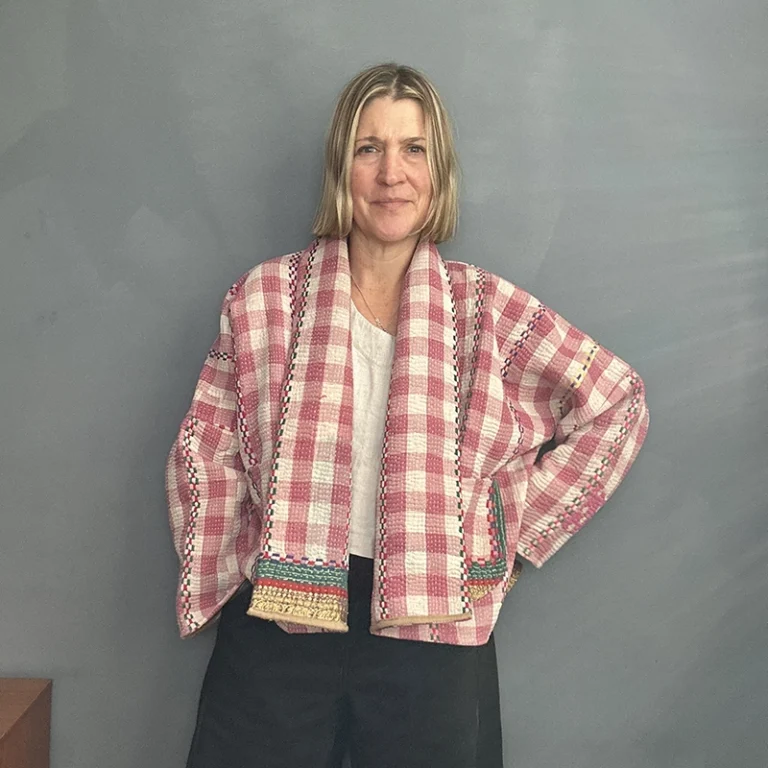 woman wearing a checkered short kantha jacket